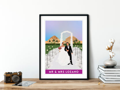 Framed wedding portrait of a couple with mountains in the background on a wooden surface.
