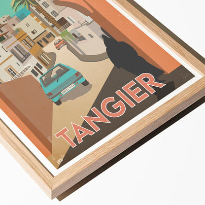 Framed artwork of a city street with a car and 'Tangier' text, featuring a wooden frame.